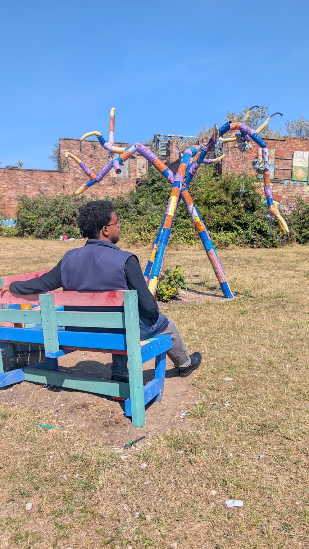 Abdi Ahmed on a brightly painted community bench in L8