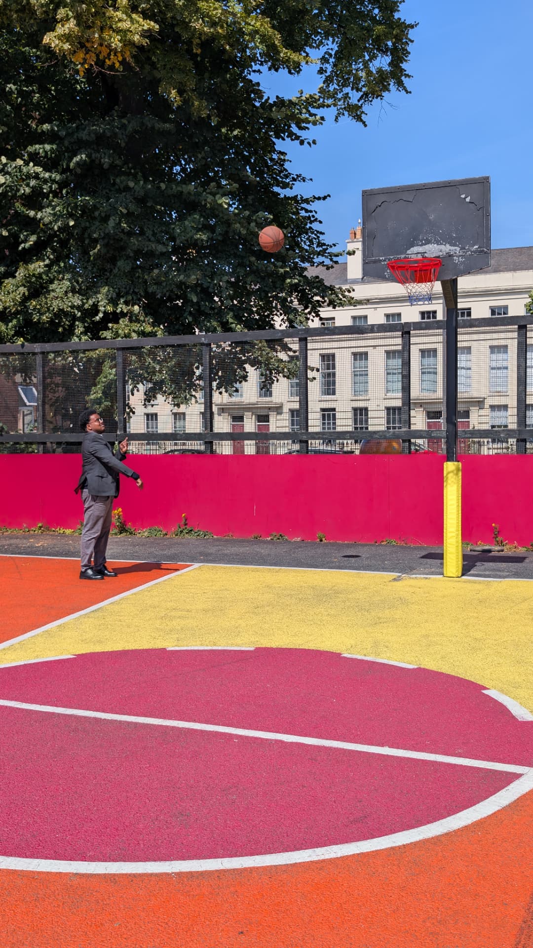 Abdi Ahmed watching the ball fly towards the hoop on the local court